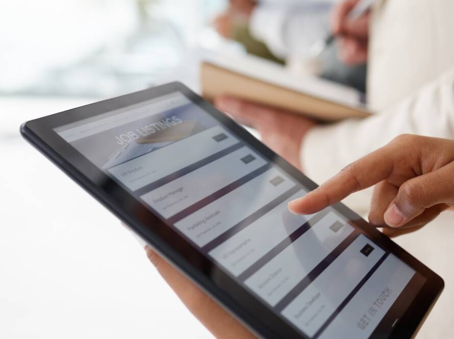 Hands, tablet and job listing advertising for hiring, opportunity or recruiting agency at the offic