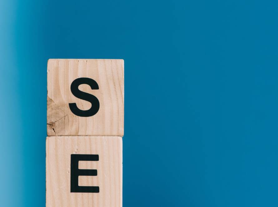 SEO word made from wooden cubes on blue background